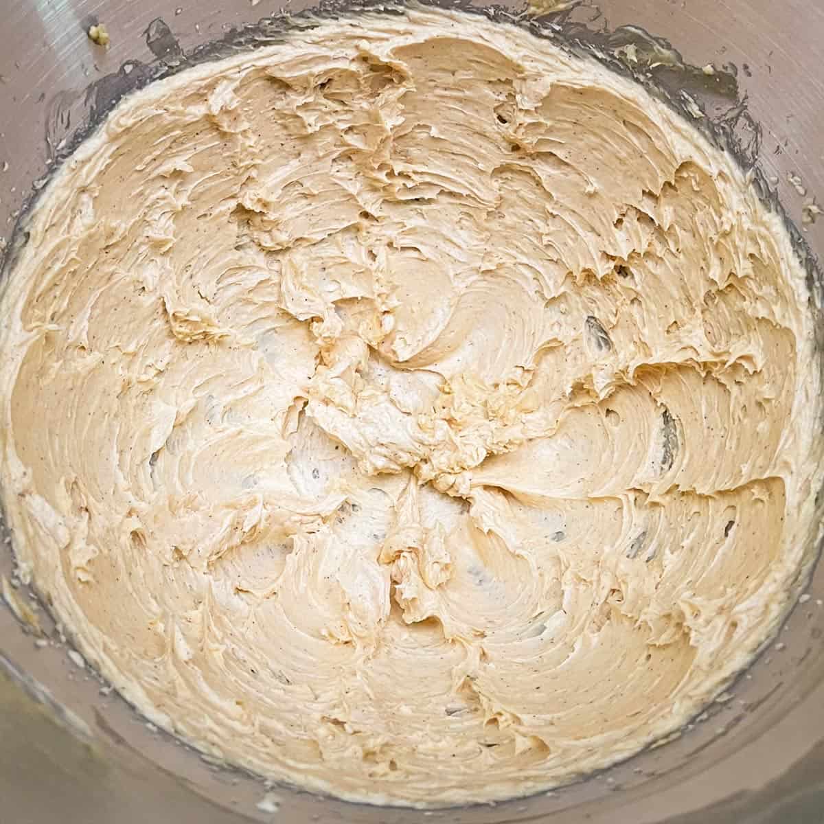 Mixed pumpkin frosting ready to be added to the cookies