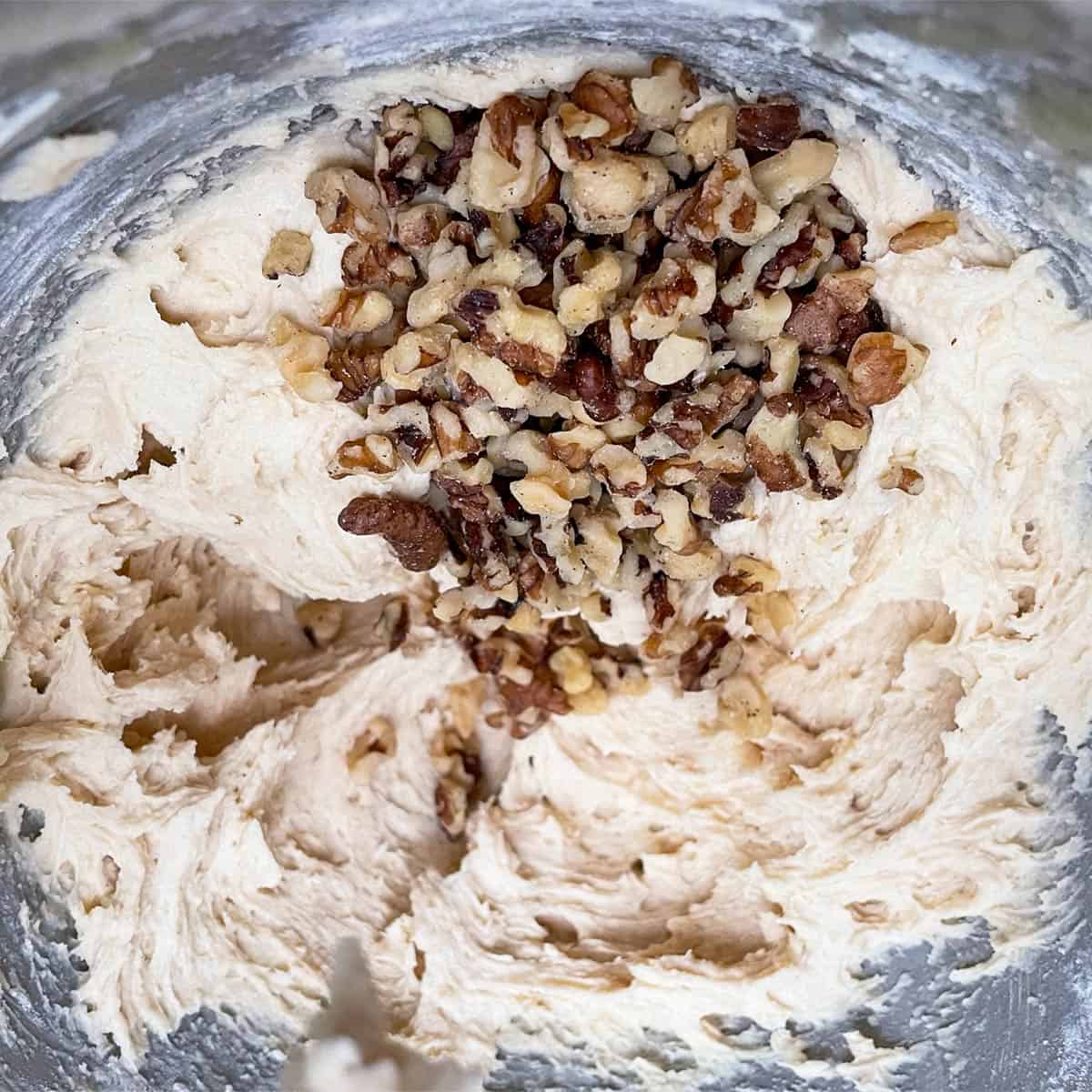 Adding the walnuts to the cookie dough.