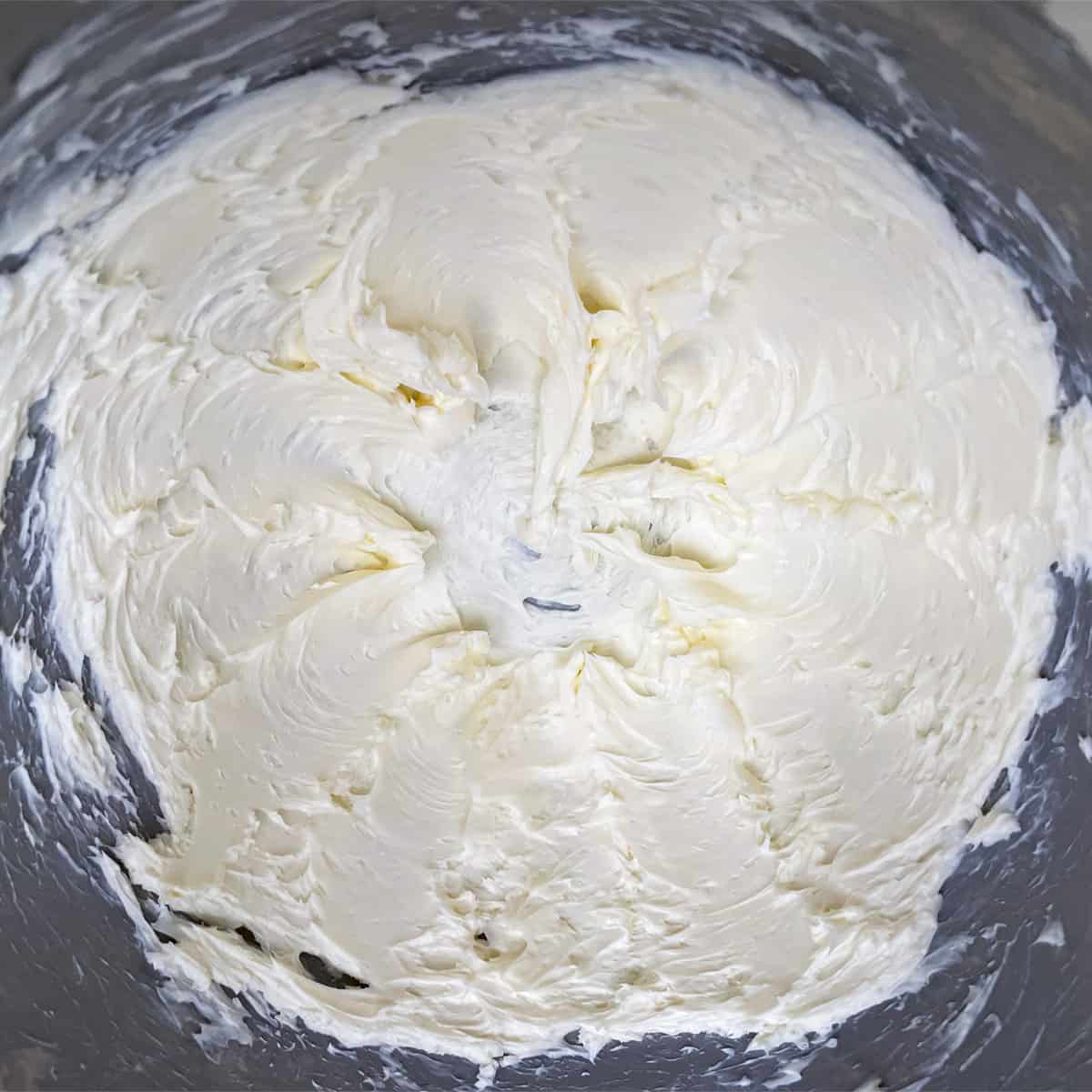 Butter that is mixed for two minutes and looks soft and creamy.