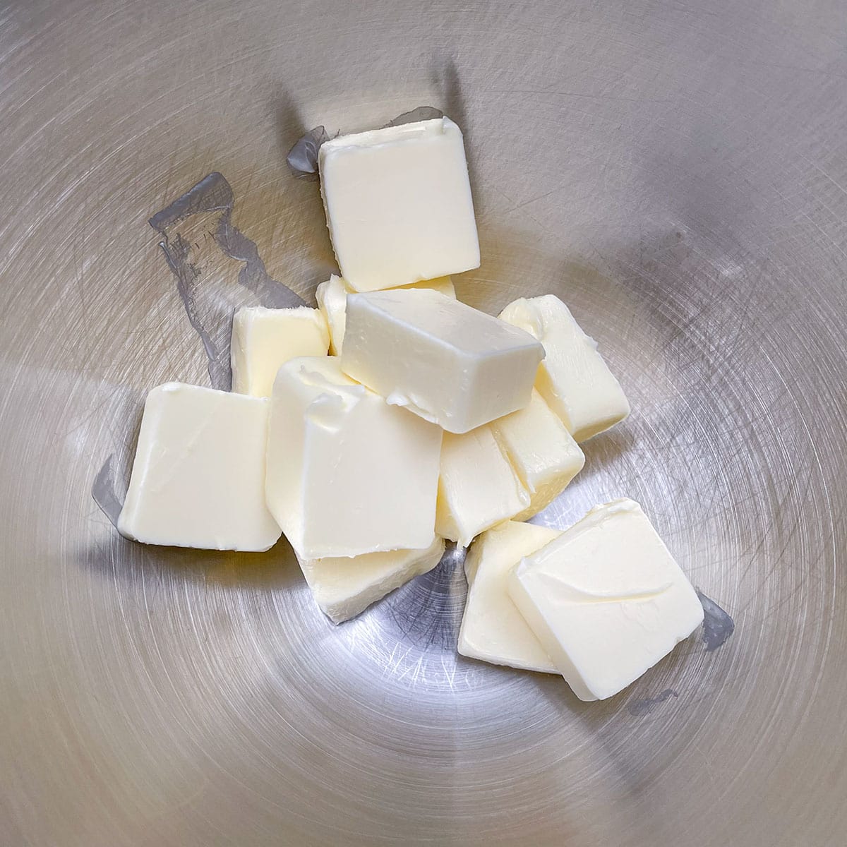 Cubed butter sitting in a mixer bowl getting ready to be creamed.