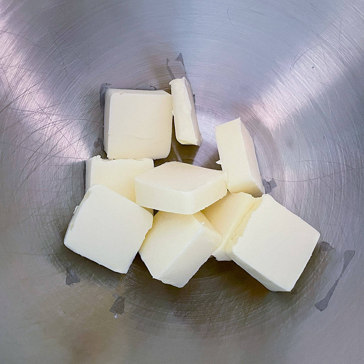 Unsalted butter that is cubed and in a mixer bowl.