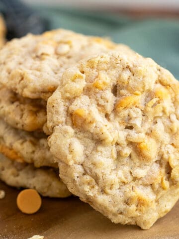 Front view of an Old Fashion Oatmeal Scotchie Cookie with a stack of the cookies behind it.