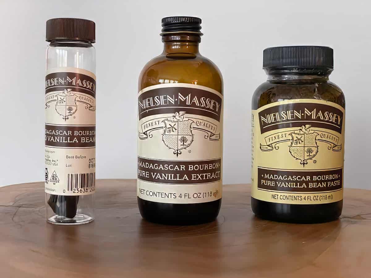 Nielsen Massey vanilla types: vanilla beans in a glass tube, vanilla extract in a 4 oz jar, and vanilla bean paste in a 4 oz jar.