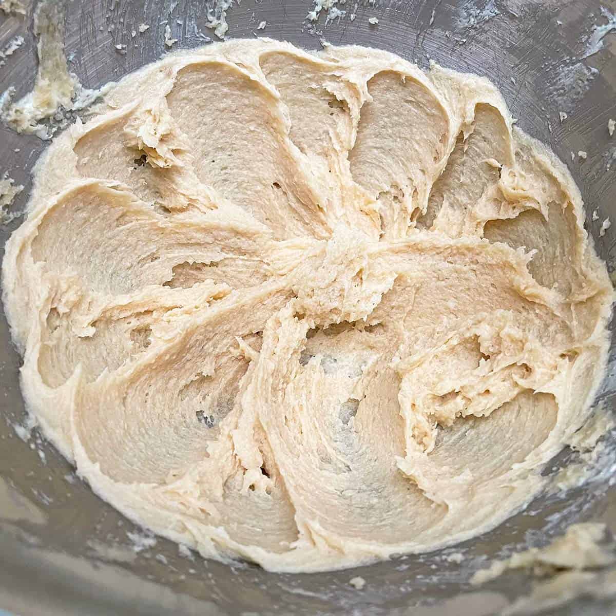 Creamed butter and light brown sugar mixed for 3 minutes in a mixer bowl.