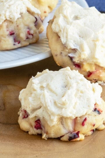Close up of Fresh apple and cranberry cookies on a wooden plank.