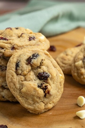 A close-up of a cranberry and white chocolate cookies showing all the bumps where the fruits and chips are.