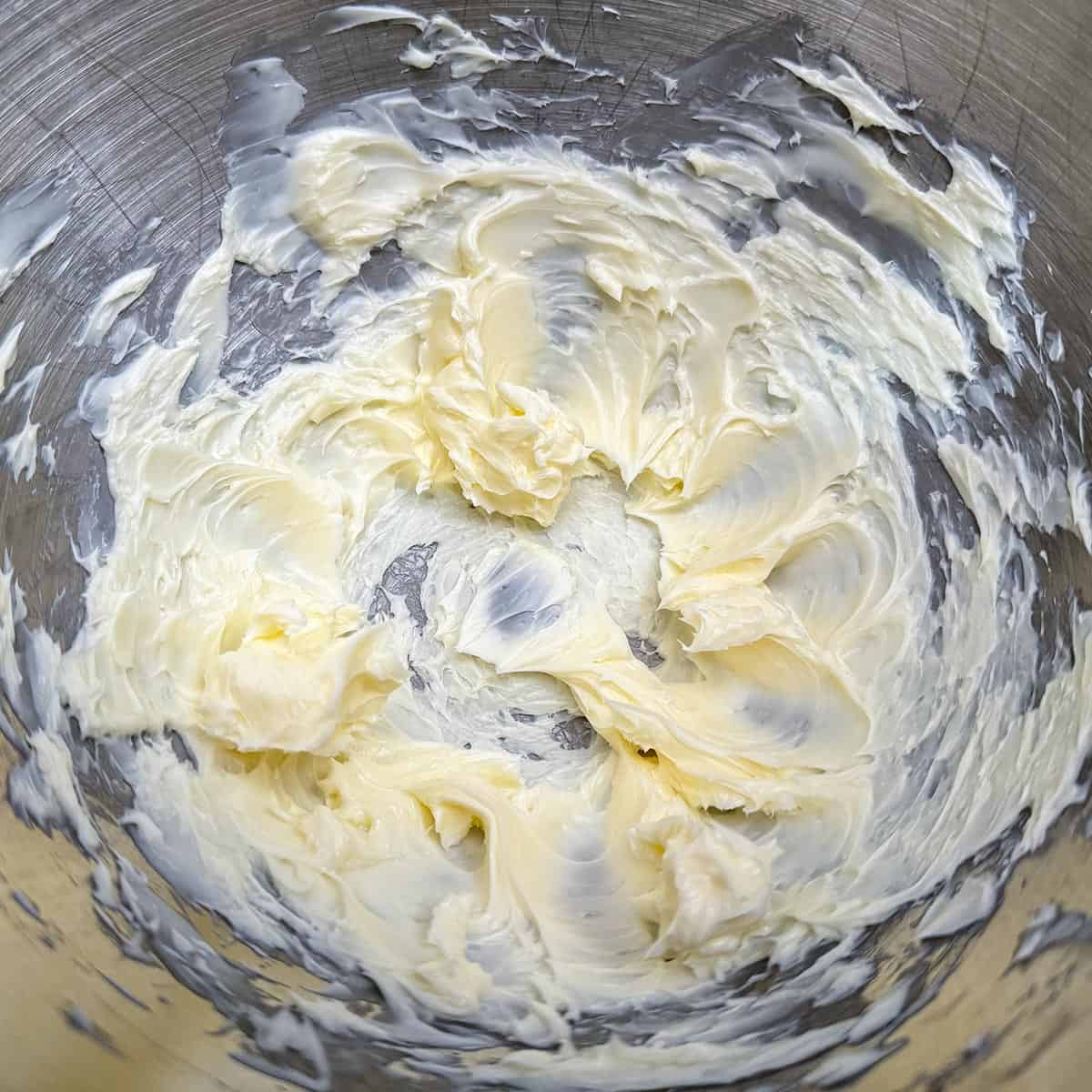 Creaming the butter in a mixer bowl for the icing.