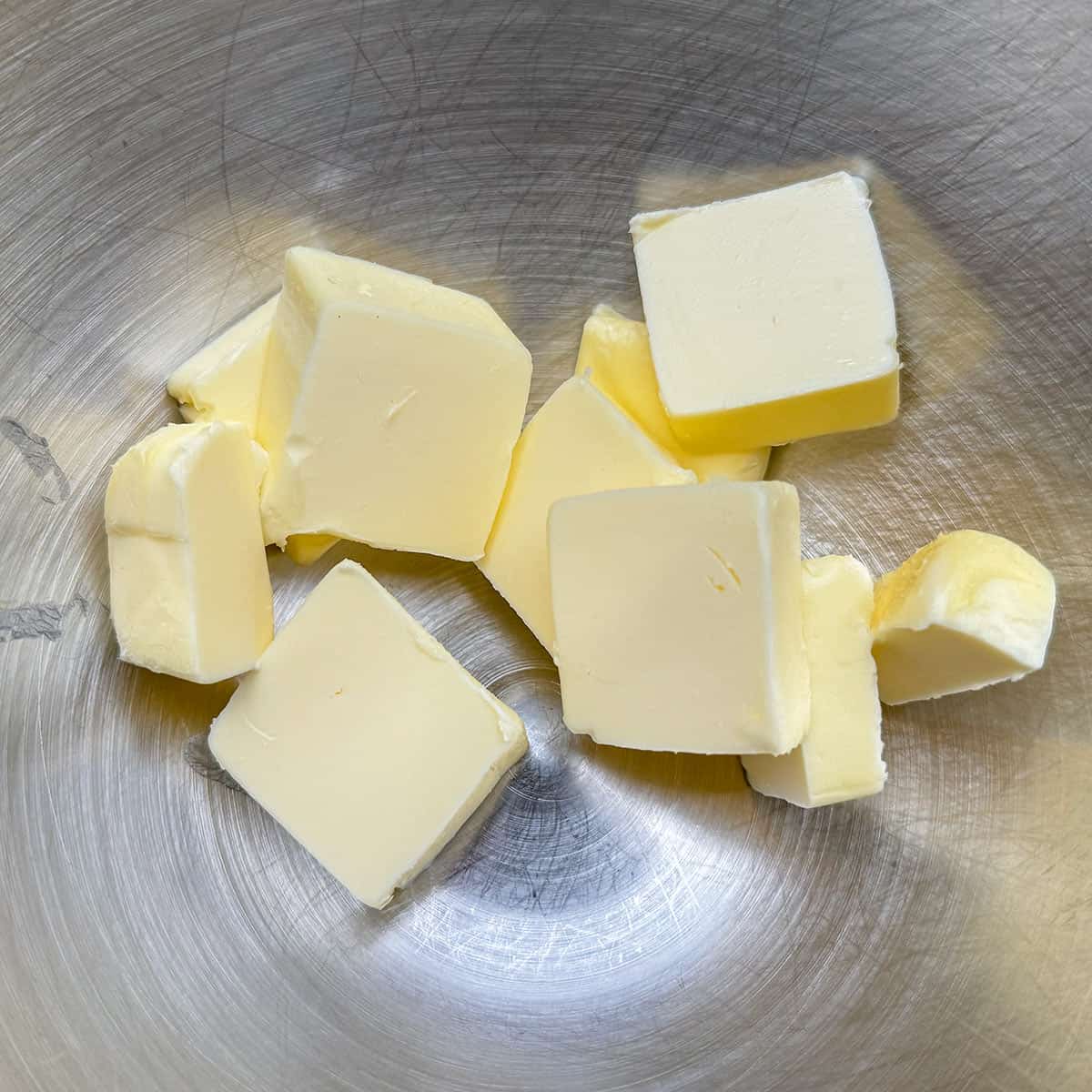 Soft cubed butter in a mixer bowl.