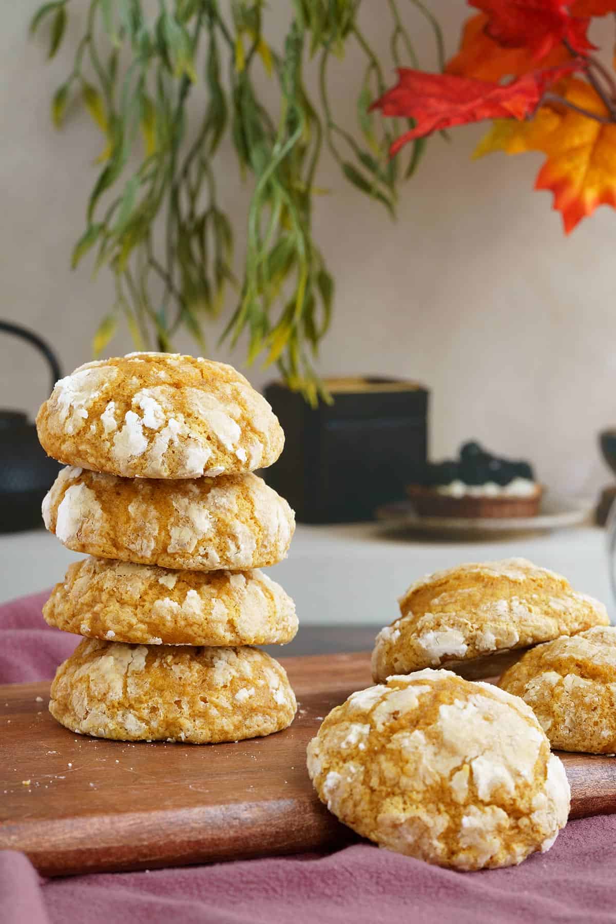 Full lenght image of a stack of soft pumpkin cookies on a wooden board.