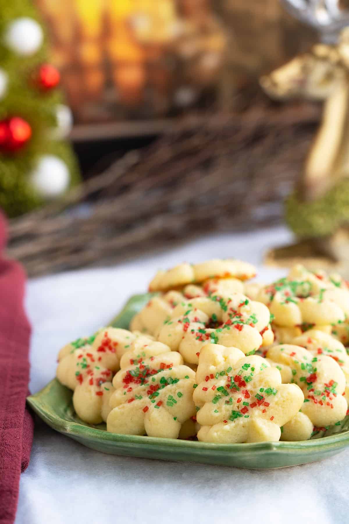 Tender cream cheese spritz cookies on a square plate for the holidays.