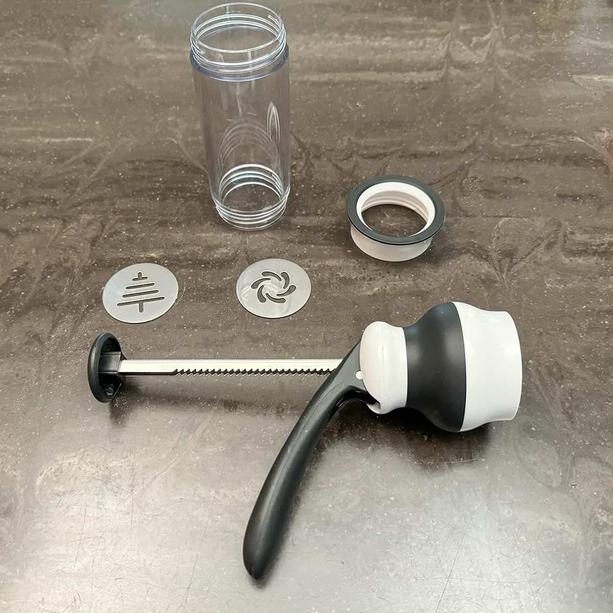 OXO cookie press in pieces.