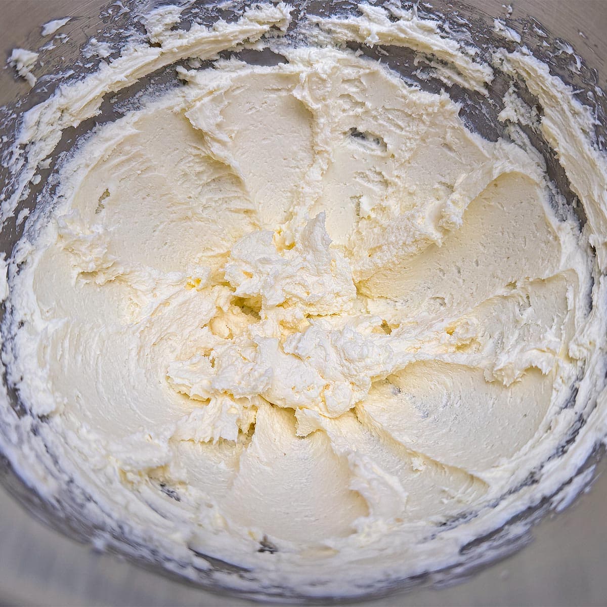 Creaming the butter and cream cheese together in a mixer.