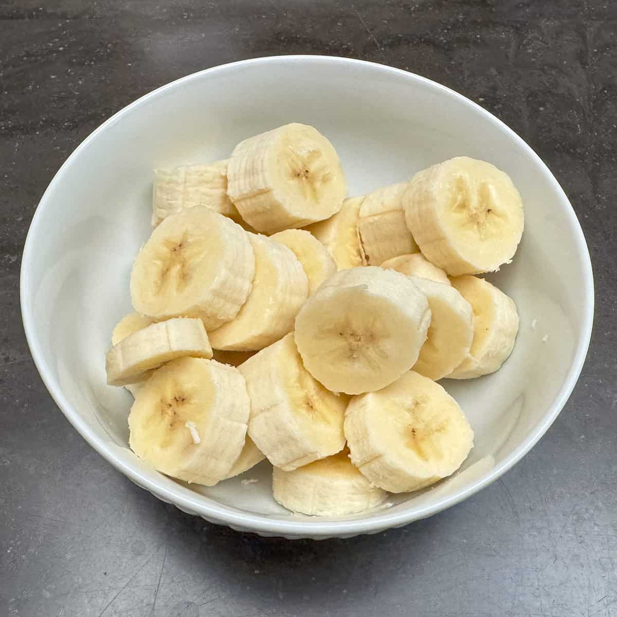 Cut up bananas in a small bowl.