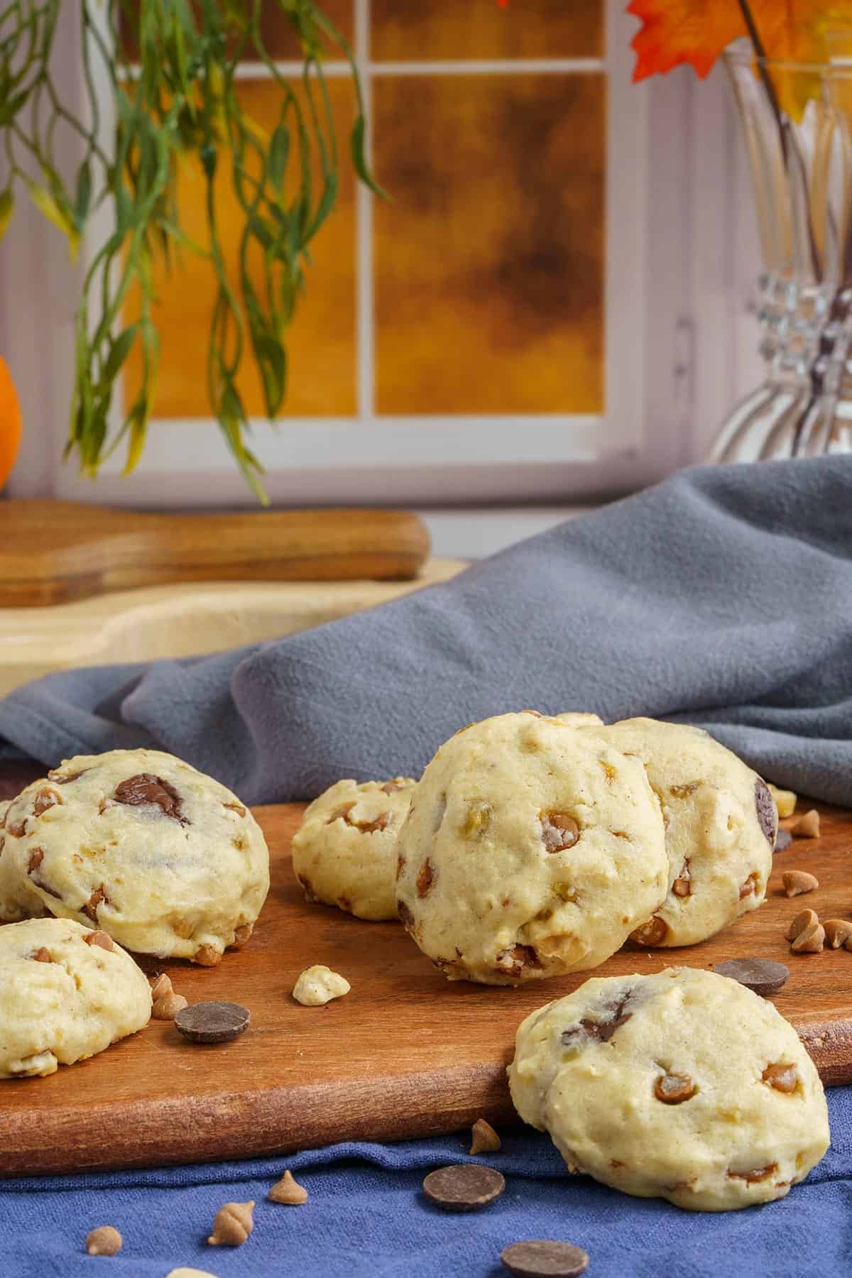 Baked banana with chocolate and caramel chip cookies on a wooden board in front of a window.