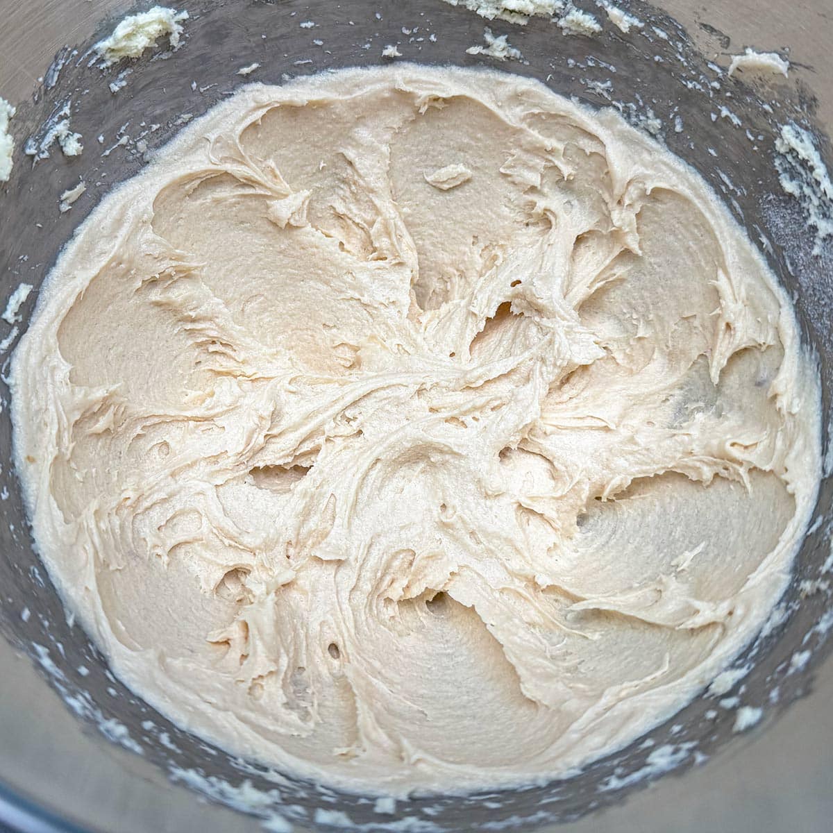 Butter, cream cheese, and sugars mixed for three minutes in a mixer bowl.