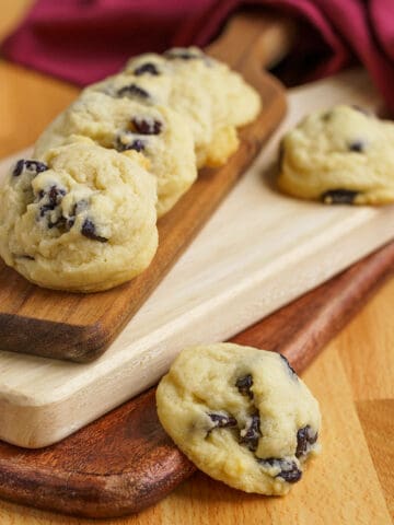 Cherry Vanilla Cookies on top of three stacked paddle shaped cutting boards.