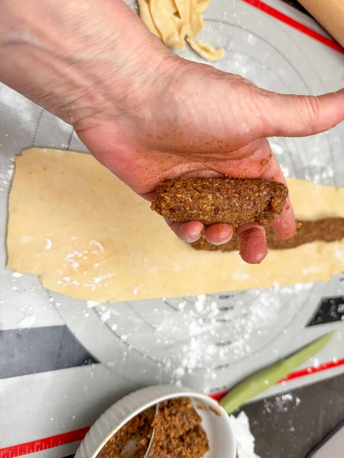 Roll the fig mixture into a small log shape to add to the middle of the rolled-out cookie dough.