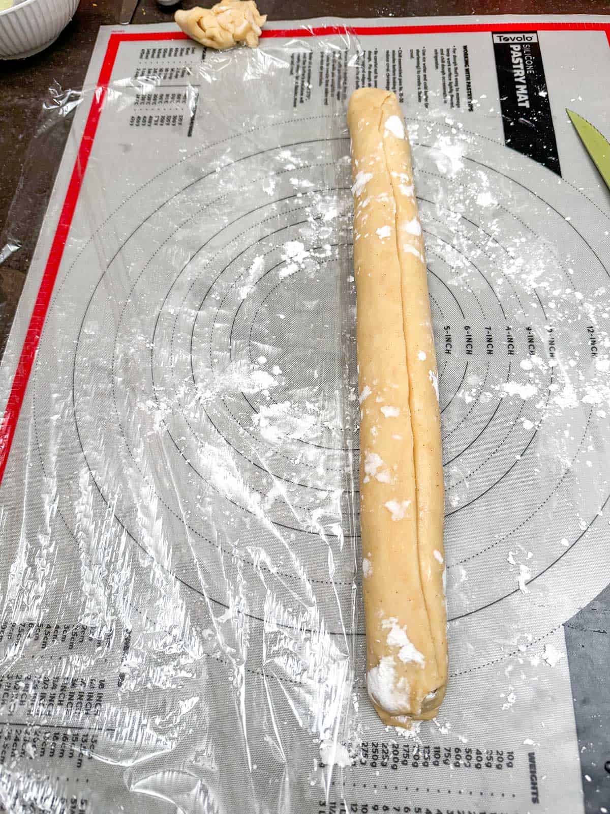 How to roll and wrap a fig roll in plastic wrap.