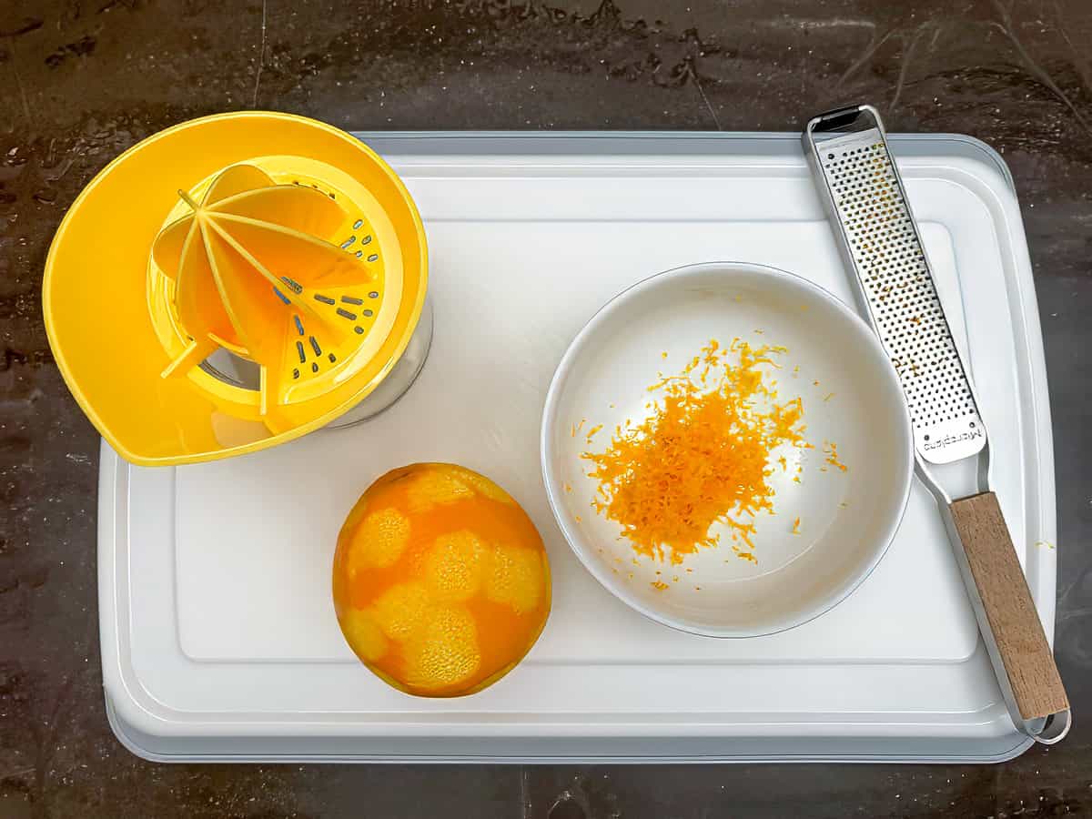A zested orange on a cutting board.