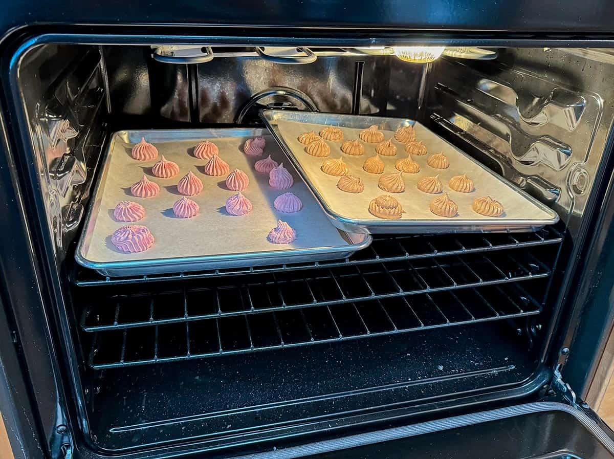 Overlapping sheet pans in oven for baking meringue.
