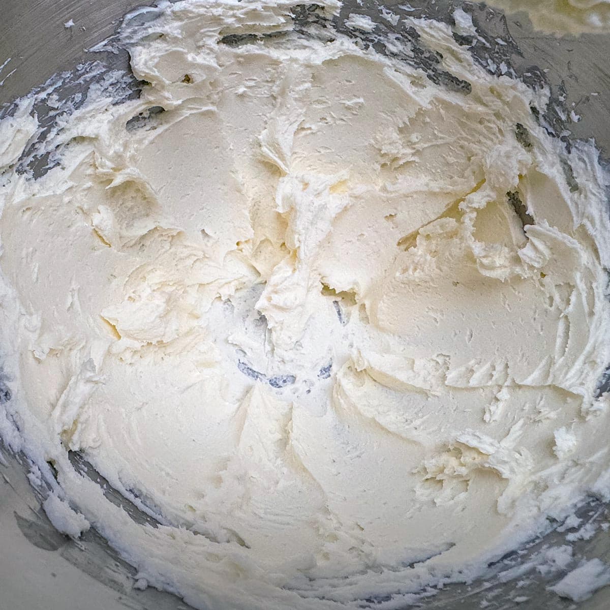 Creaming the butter and cream cheese in a mixer.
