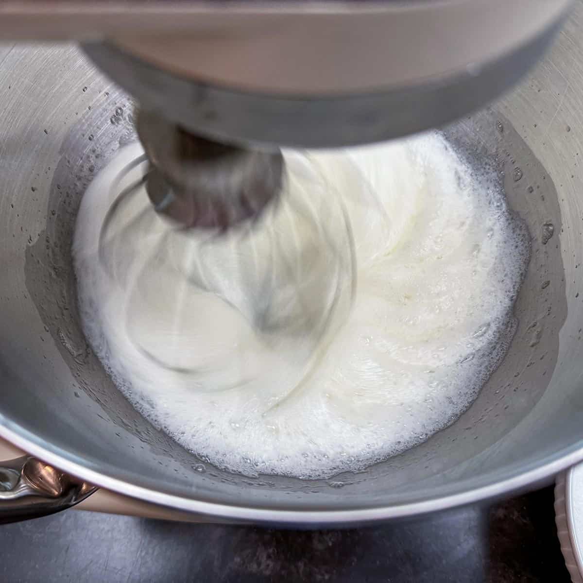 Egg white that are frothy in mixer bowl.