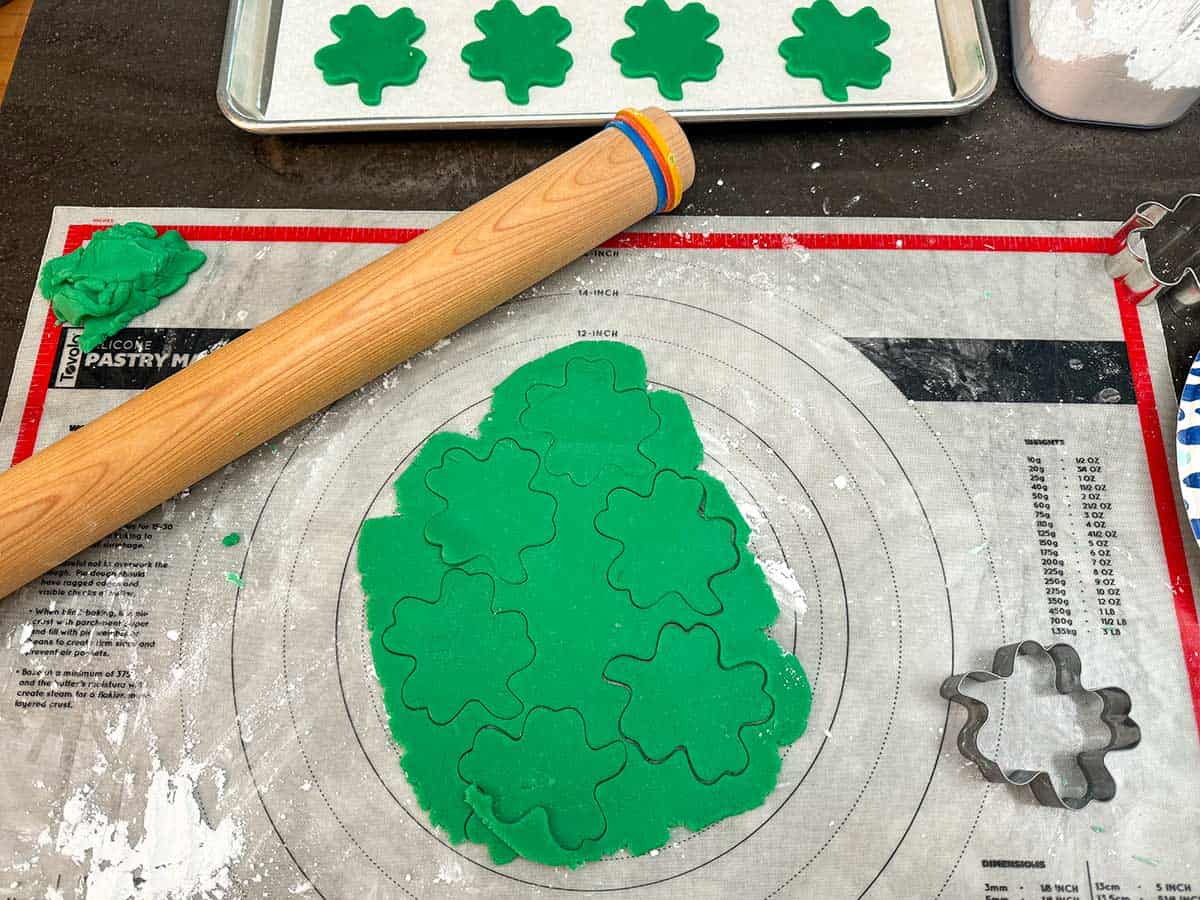 Cookie dough rolled out and cut out with a shamrock cutter.