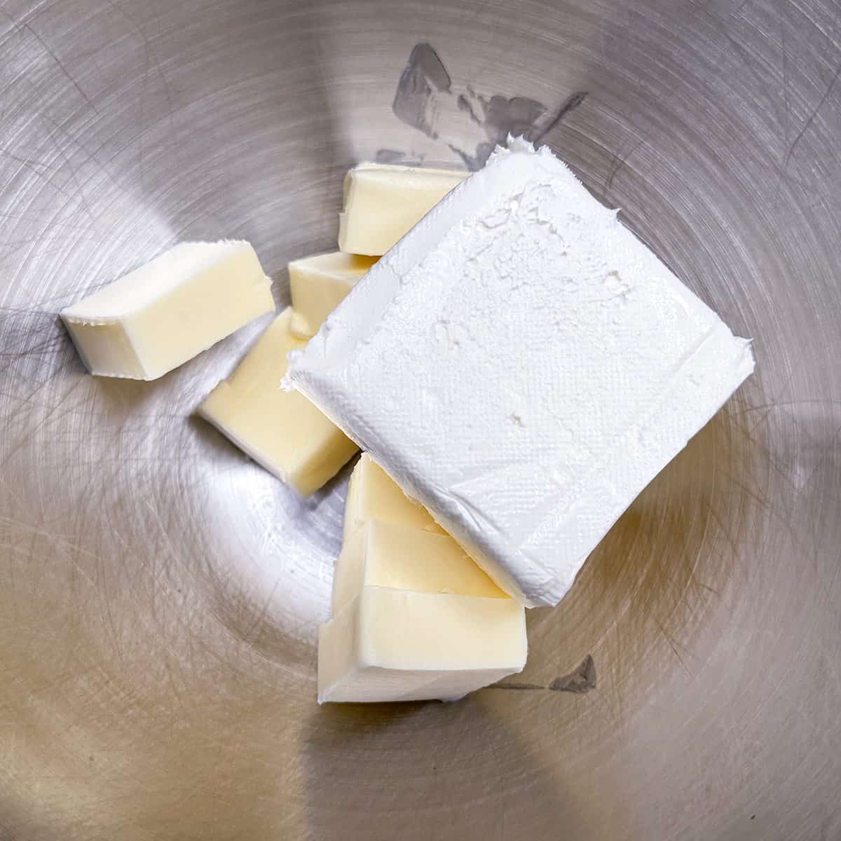 Cubed butter and a block of cream cheese ready to be mixed.