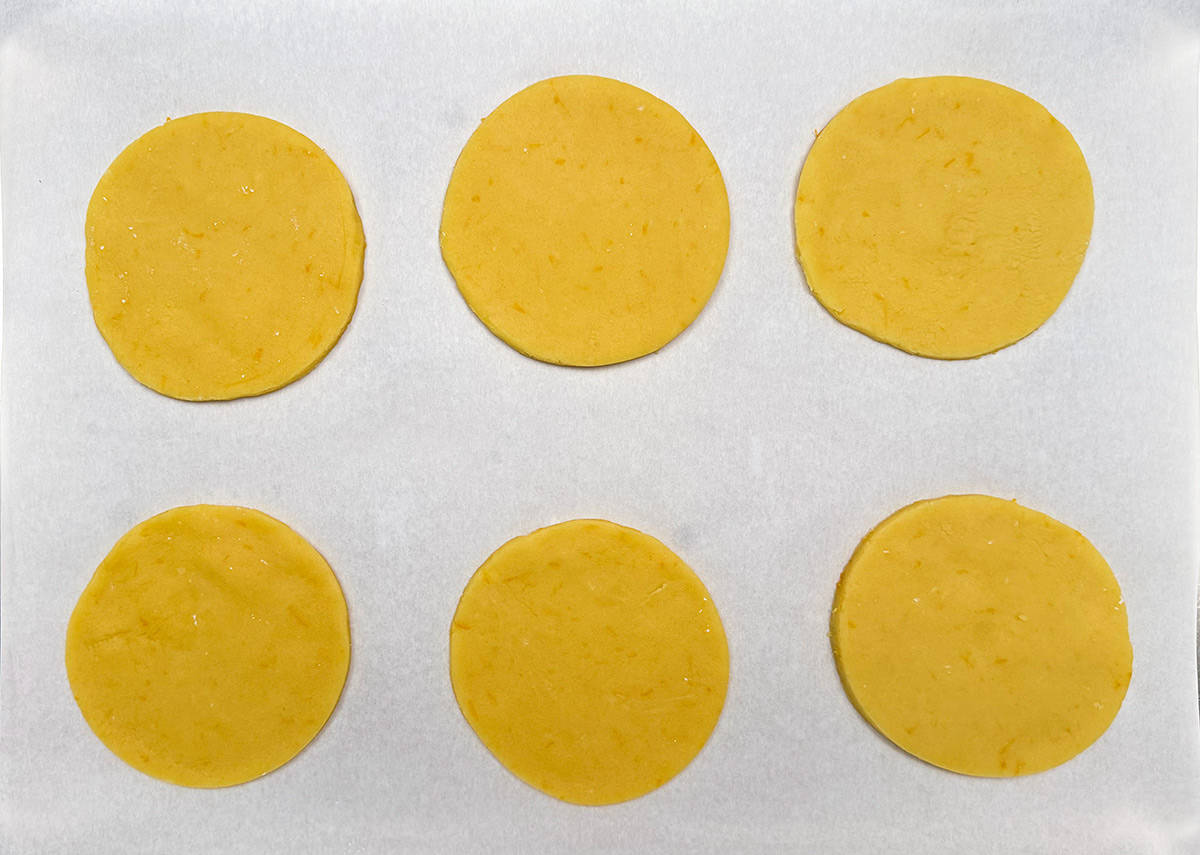 Four inch cut out round cookies ready to be baked.
