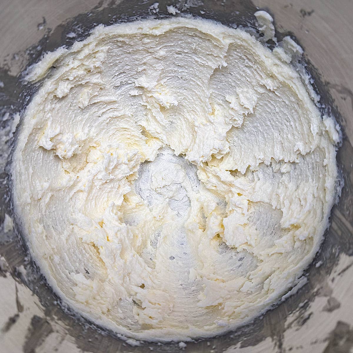 Creaming the butter in a mixer.