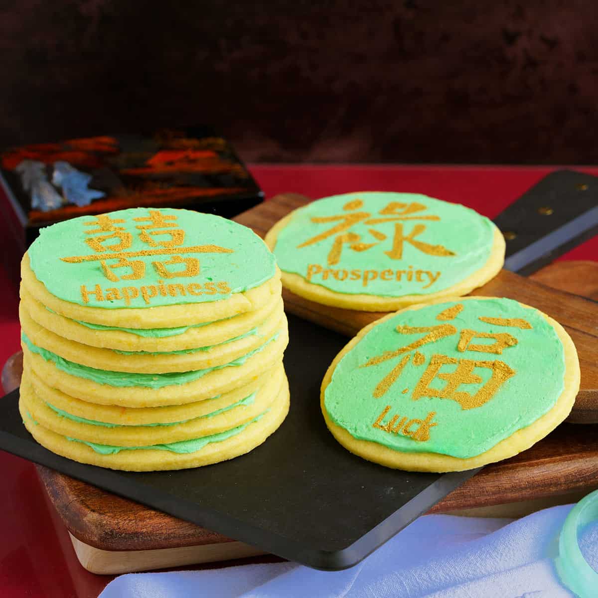Orange Sugar Cookies with Orange Buttercream icing decorated with colors for the Chinese New Year.
