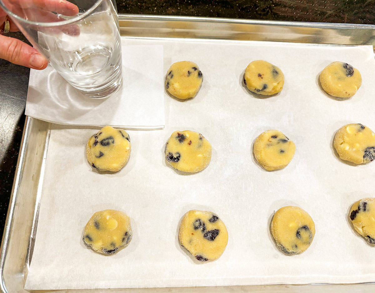 Flatten the cookies with parchment paper square and the bottom of a glass.