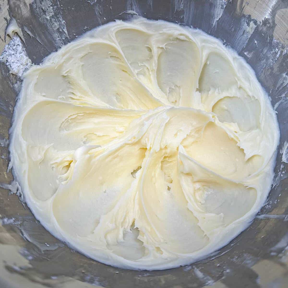 Mixing powdered sugar into the butter-cream cheese mixture. Very smooth and creamy.