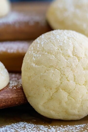 Cream cheese cookies propped up against wooden planks.