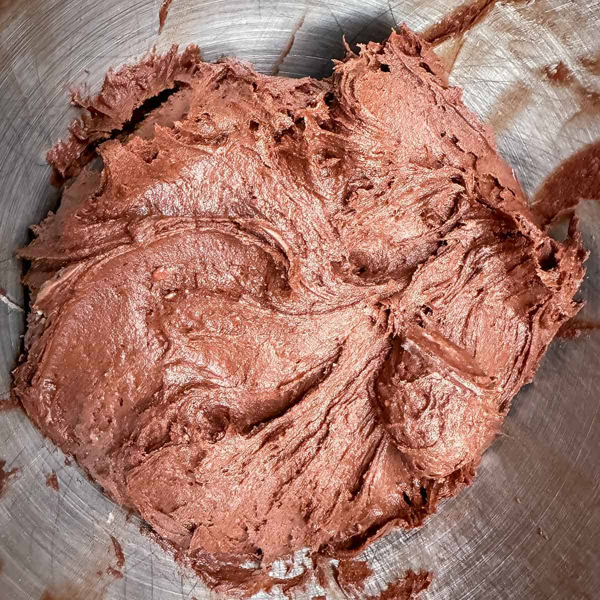 Chocolate cookie mixture all mixed in a mixer bowl.