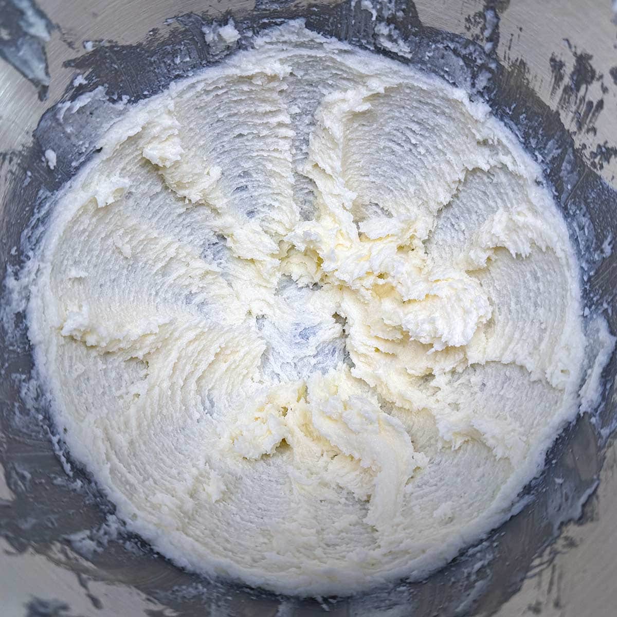 Mixing butter and sugar in a mixer bowl.
