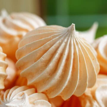 Close up of a single tangerine meringue cookie.