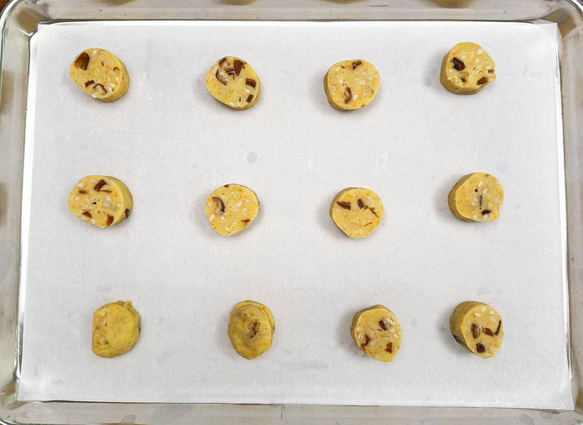 Cookies placed on a parchment lined cookie sheet pan ready for the oven.