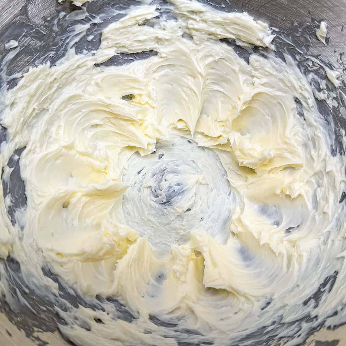 Creamed butter in a mixer bowl.