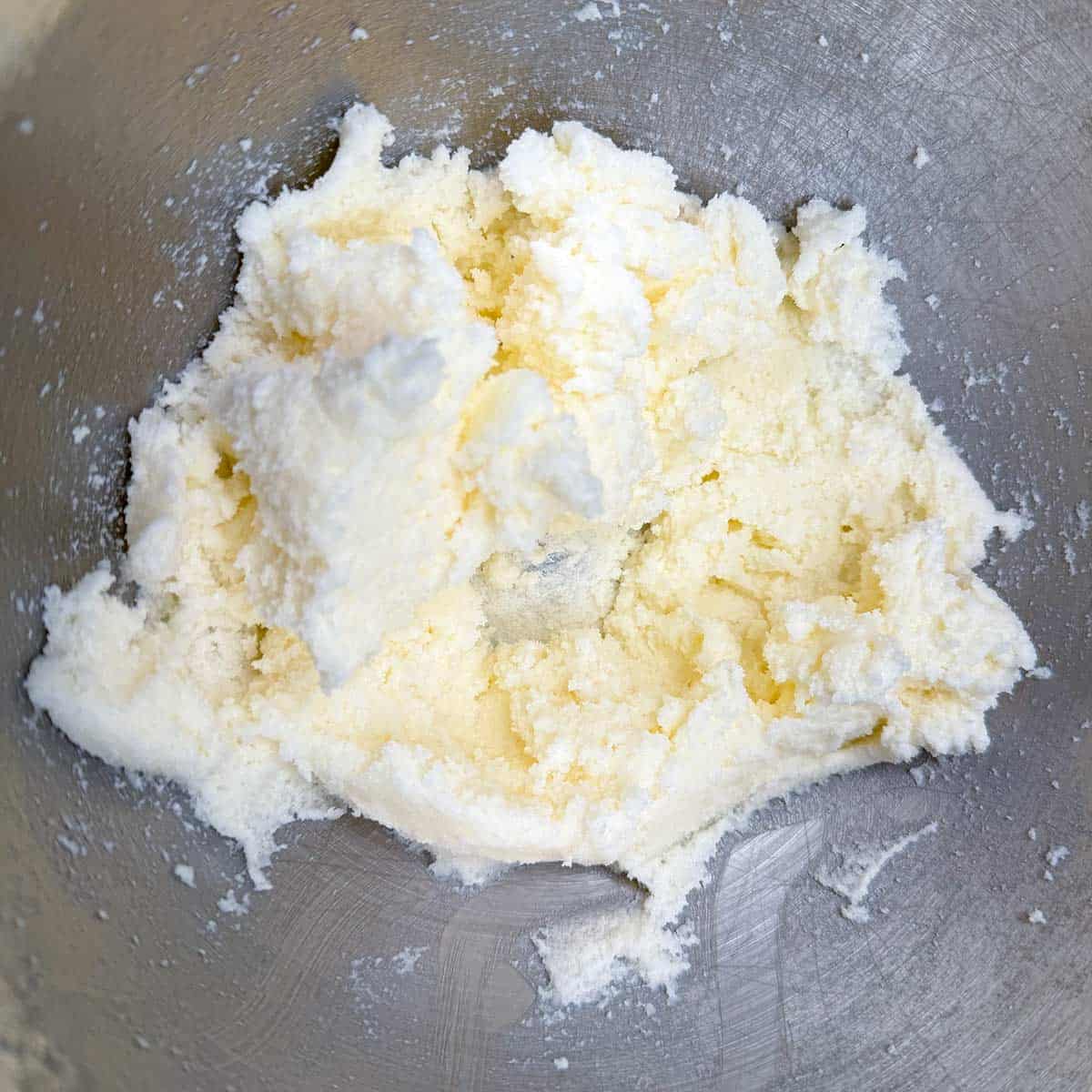 Mixing butter and sugar together in a mixer bowl.
