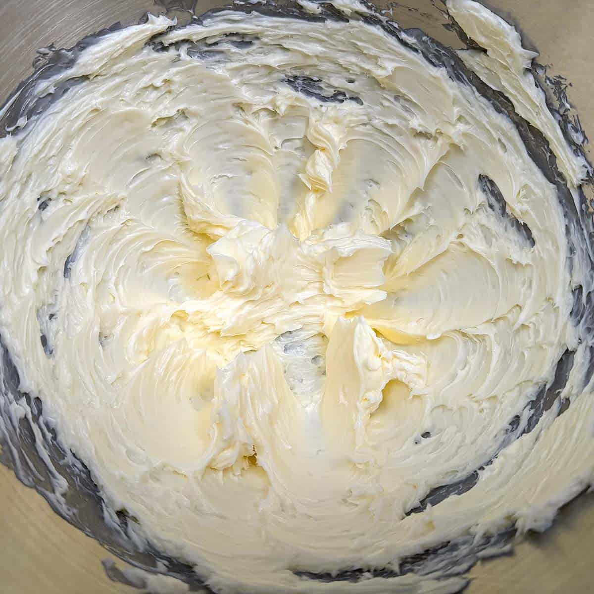 Creaming the butter in a mixer bowl.