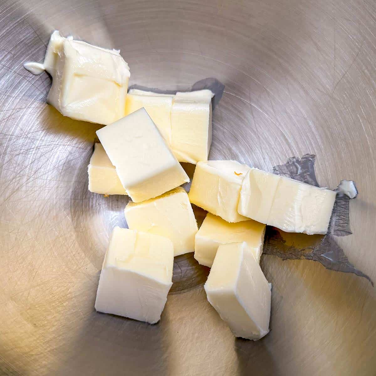 Cubed butter in a mixer bowl.