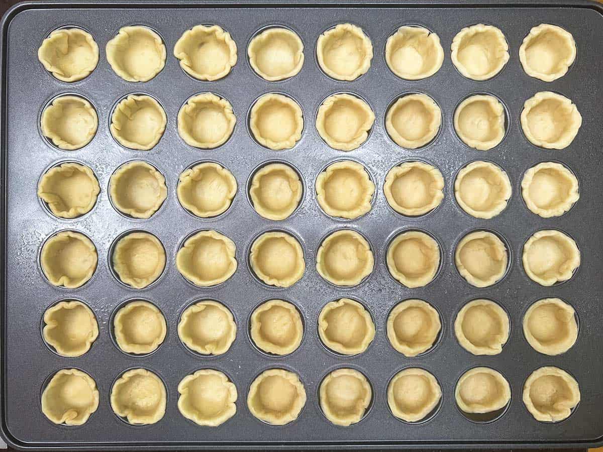 All the dough for the cookie cups has filled the 48-cup pan.