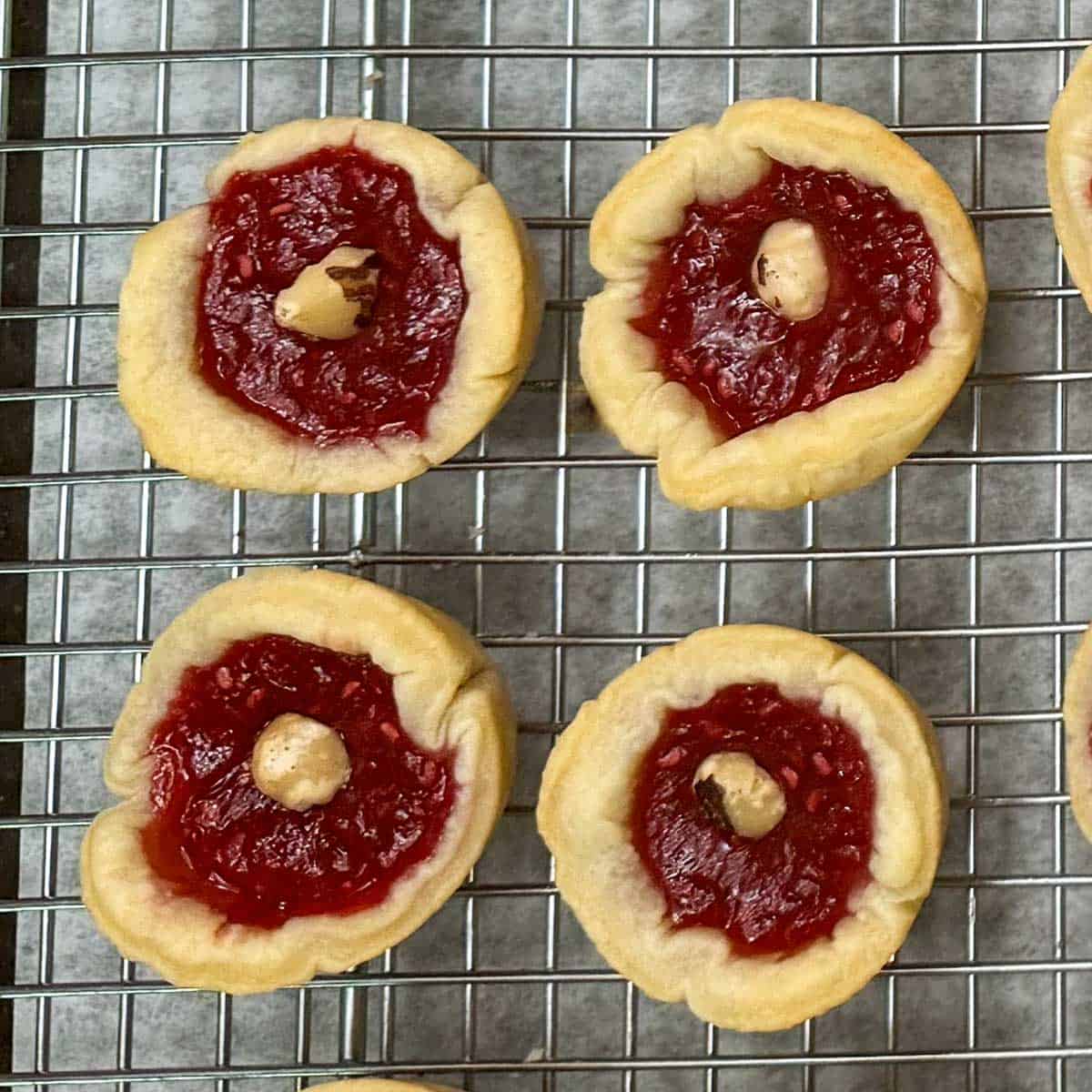 Adding a hazelnut to the baked cookie cups.