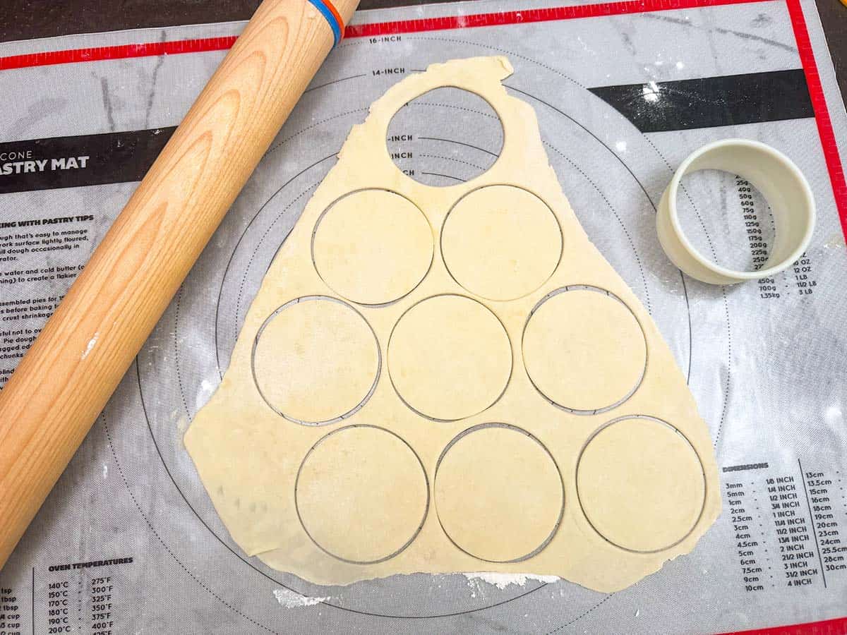 Cookie cup dough rolled out and cut into circles with cookie cutter.