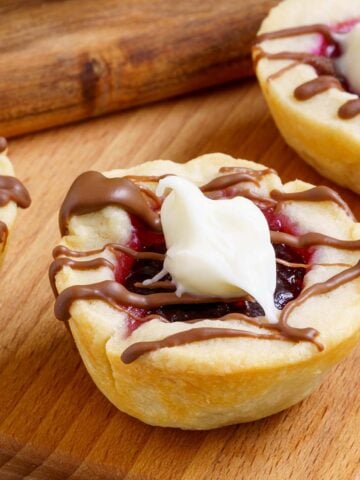 Raspberry with chocolate Cookie Cups on wooden planks-feature image.
