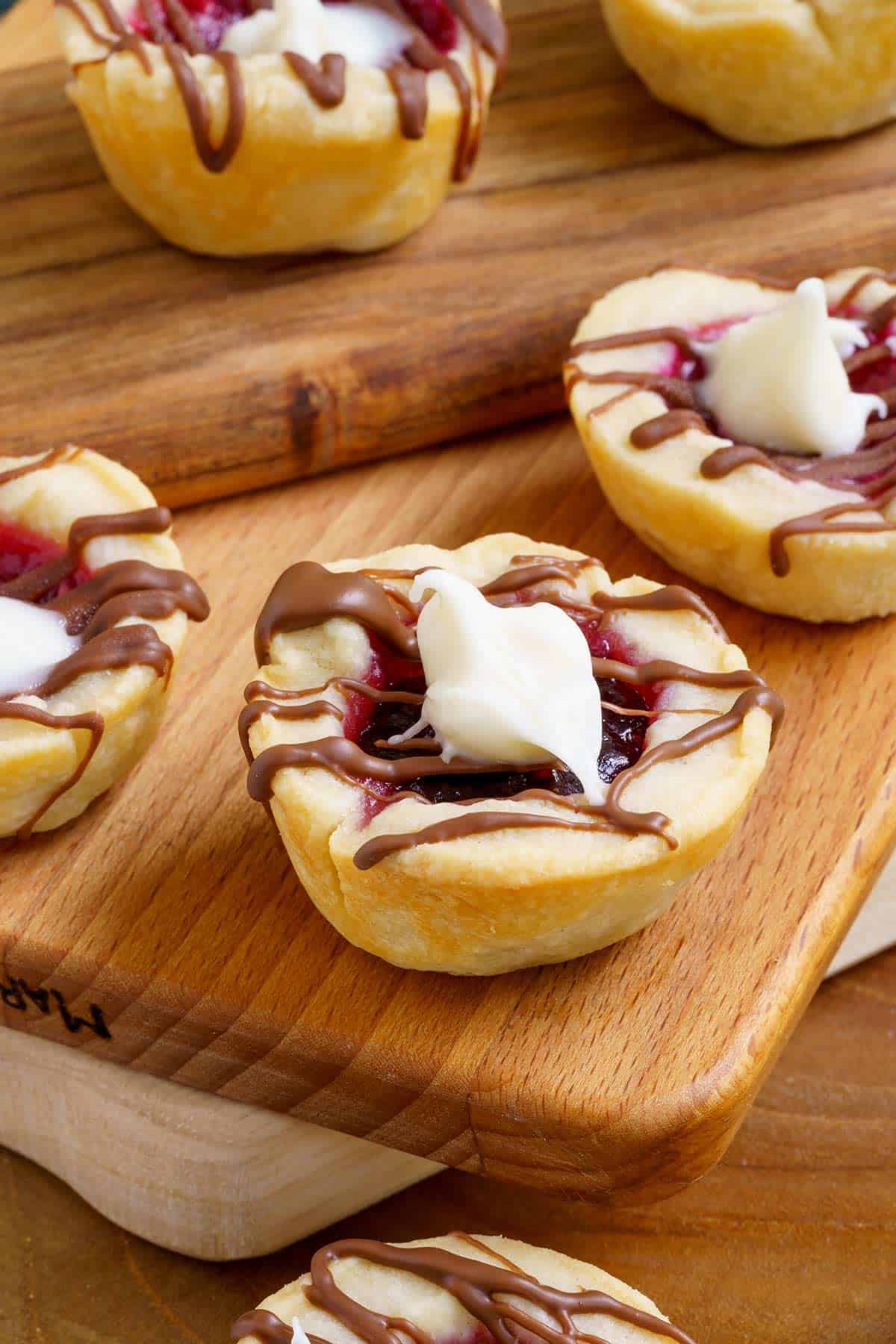 Raspberry with chocolate Cookie Cups on wooden planks-feature long image.