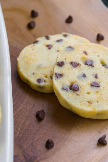 Shortbread cookies with orange anise and chocolate chips on a wooden board.