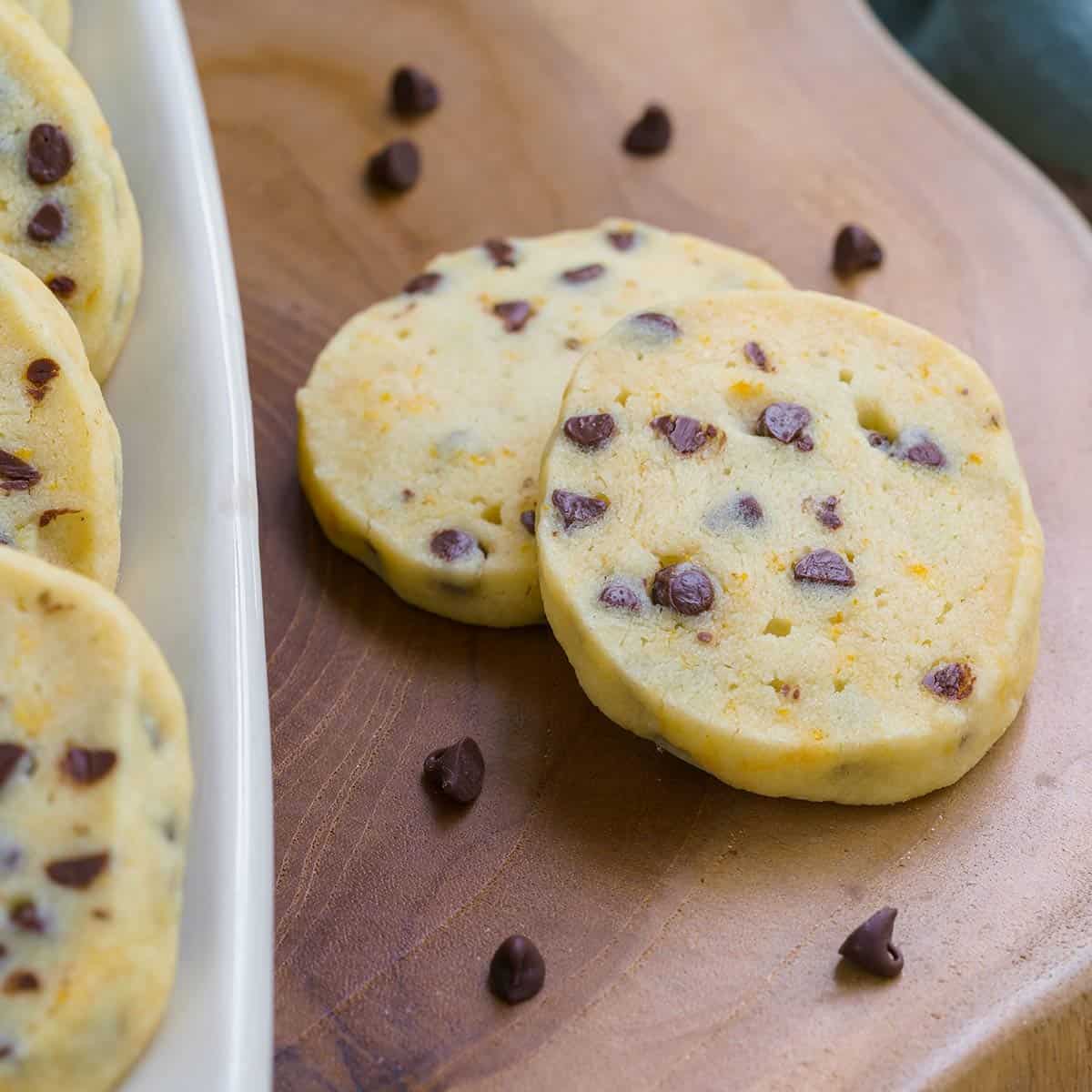 Shortbread cookies with orange anise and chocolate chips on a wooden board.