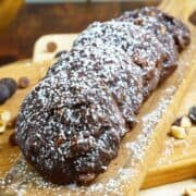 A line of the chocolate hazelnut cookies with espresso on a wooden plank.